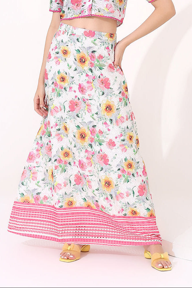 Floral skirt with pink trim worn by a person on a white background