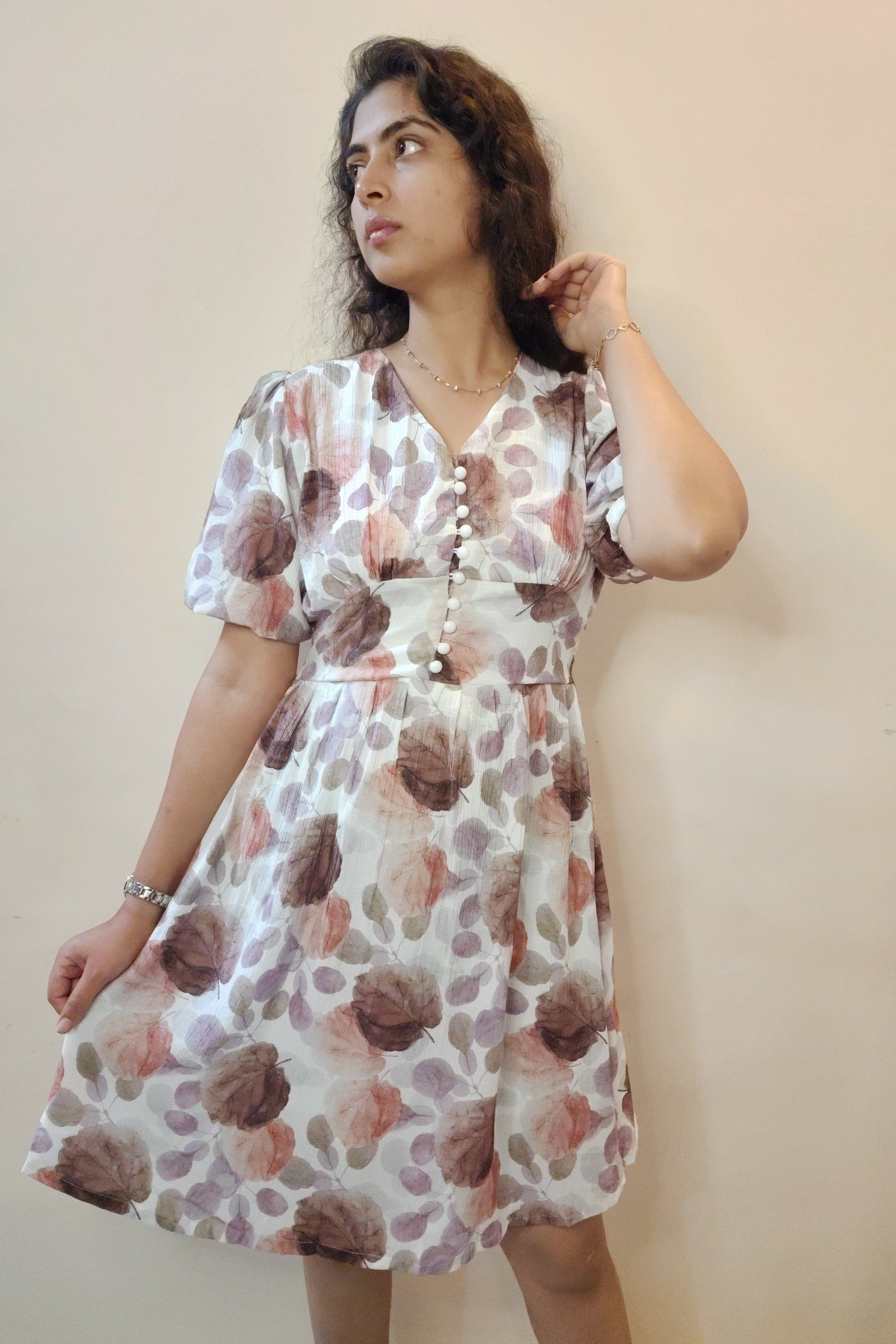 Woman wearing a floral dress on a plain background