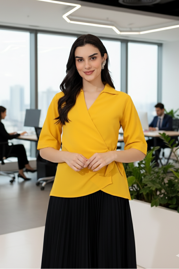 Woman in a yellow top and black skirt standing in an office setting
