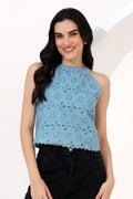 Woman wearing a light blue sleeveless halter neck embroider top
