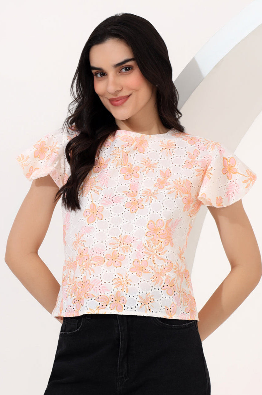 Woman wearing a floral blouse with a plain background