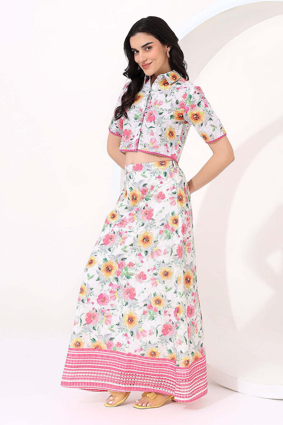 Floral skirt with pink trim worn by a person on a white background