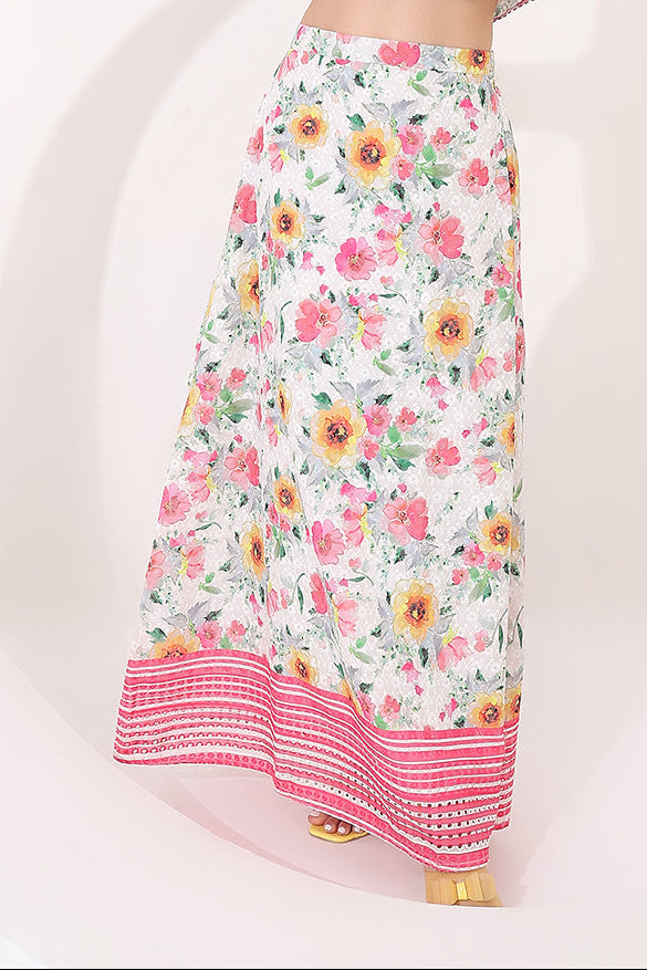 Woman wearing a floral two-piece outfit against a white background