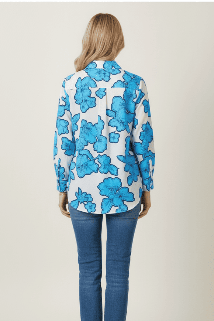 Person wearing a blue floral blouse and jeans on a white background