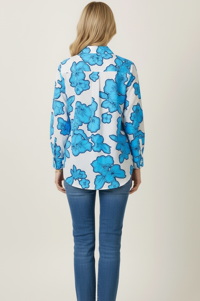 Woman wearing a blue floral blouse and jeans on a white background