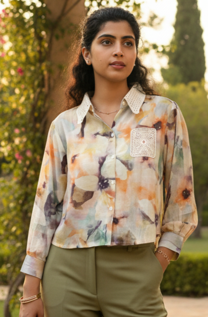 Woman wearing a colorful floral shirt with a blurred natural background
