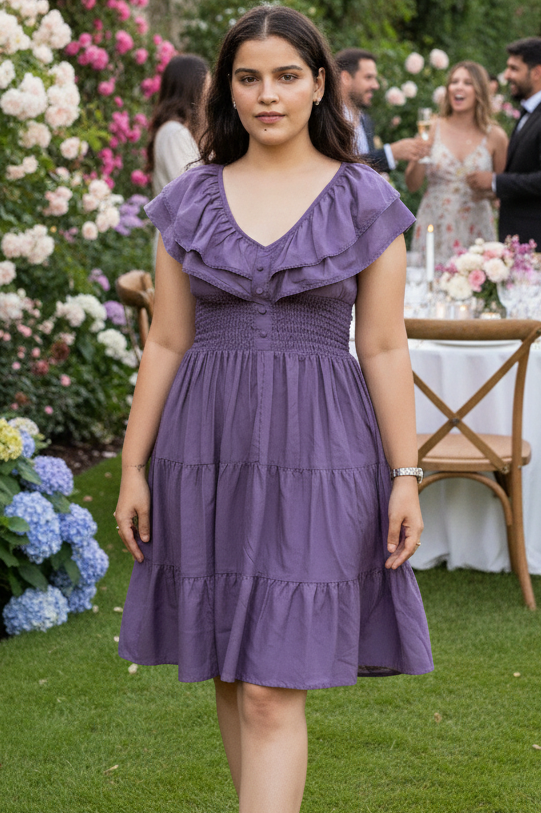Woman in a purple dress standing in a garden with floral decorations and people in the background.