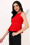 Woman wearing a red sleeveless top against a white background