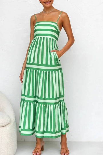 Green and white striped dress worn by a person on a white background