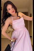 Woman in a pink dress posing indoors