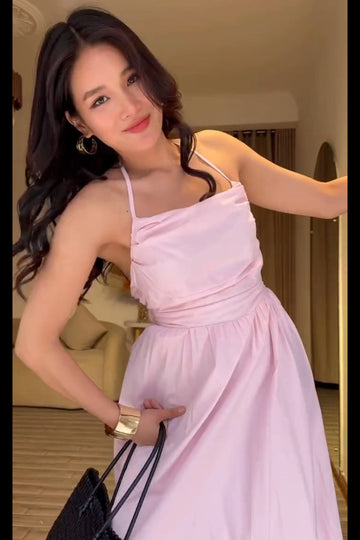 Woman in a pink dress posing indoors