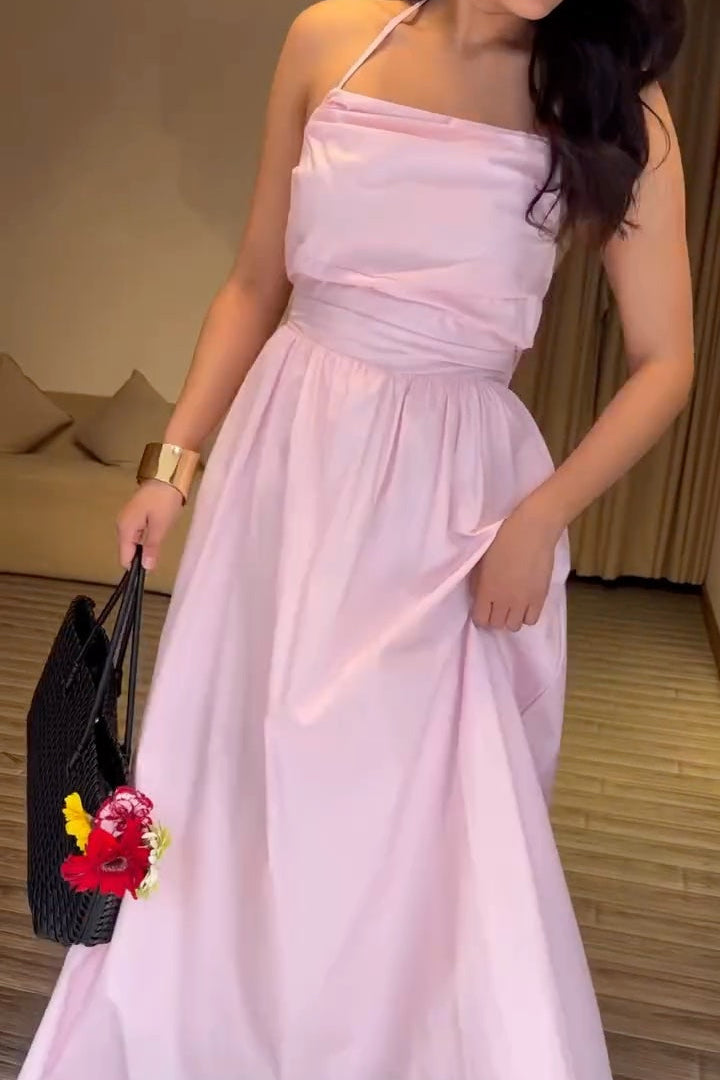 Woman in a pink dress posing indoors