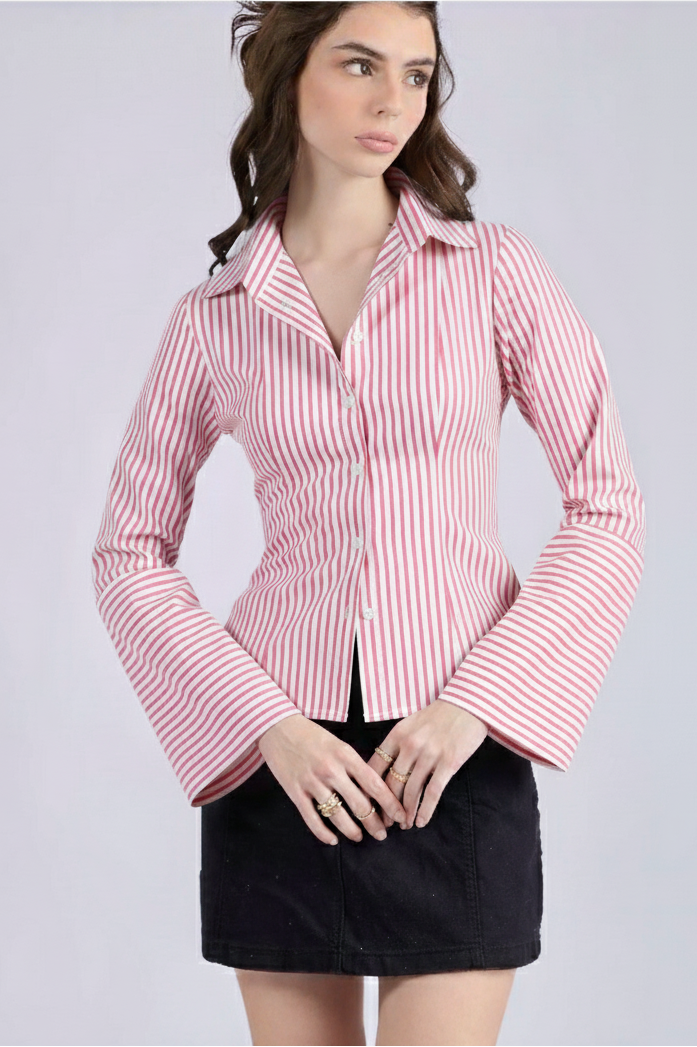 Woman wearing a pink and white striped shirt with a gray background